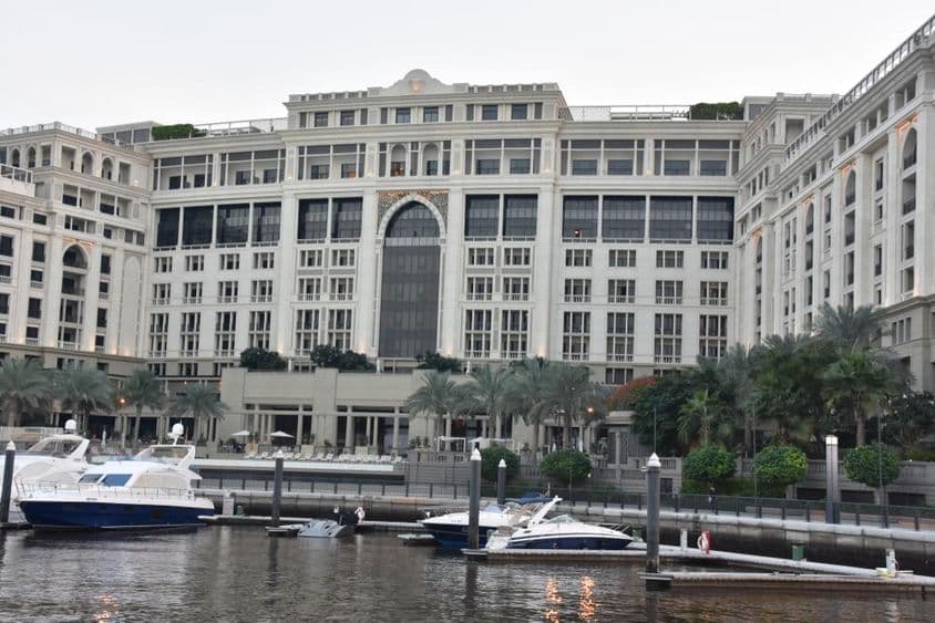 Hotel Palazzo Versace de Dubái, con lanchas motoras oscilando en el agua cerca.