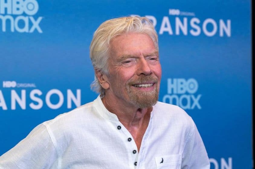 Richard Branson frente a un fondo azul.