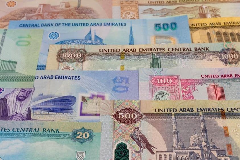 Billetes de denominación 20, 50, 100, 500, 1000 dirhams sobre una mesa.
