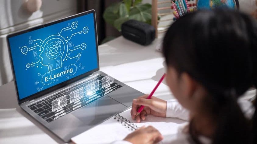 Escolar estudiando material educativo en casa.