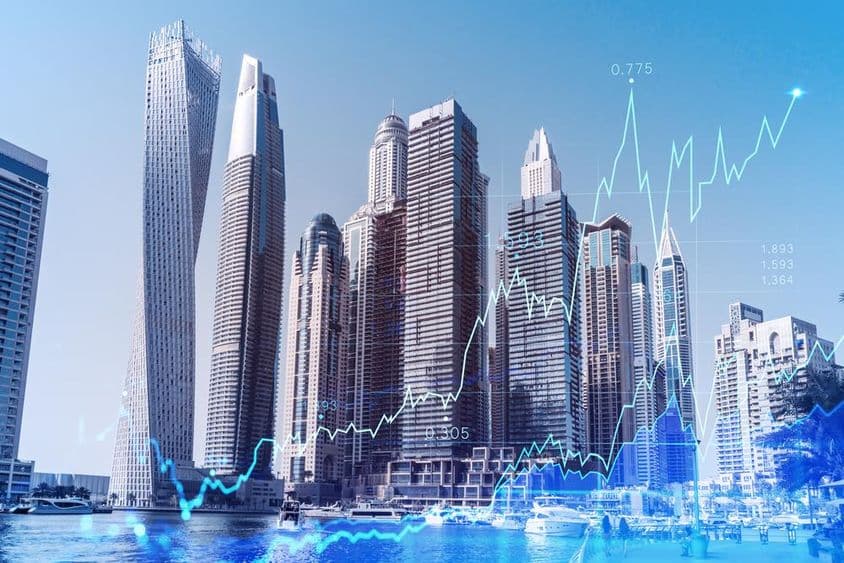 Centro de negocios de Dubái con gráfico de forex superpuesto.