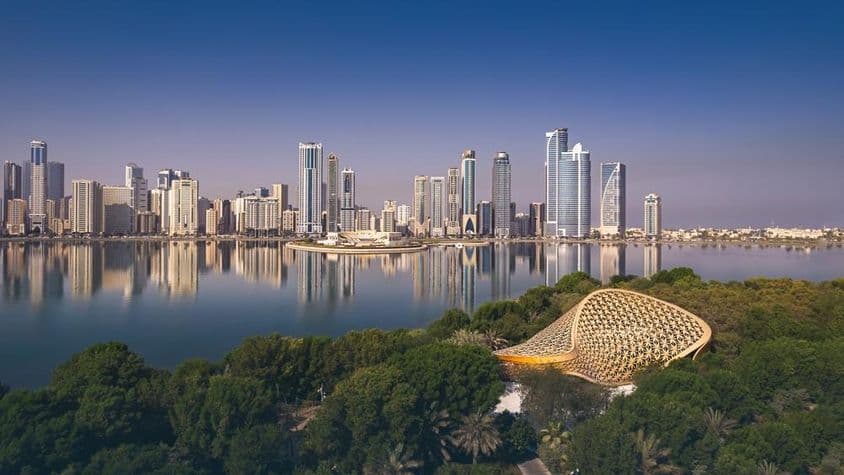 Captura de dron de la ciudad de Sharjah mostrando la belleza de su paisaje y horizonte.