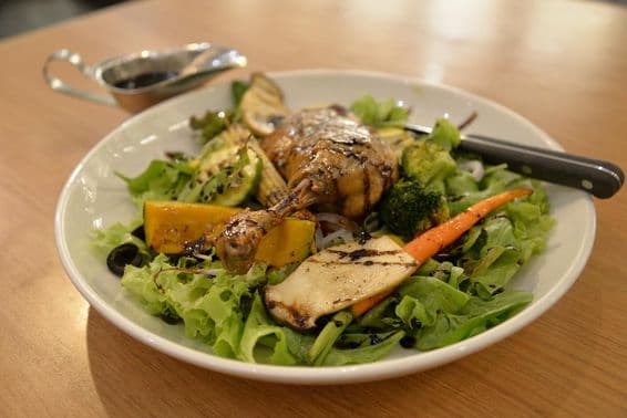 Pato tierno en un plato de ensalada.