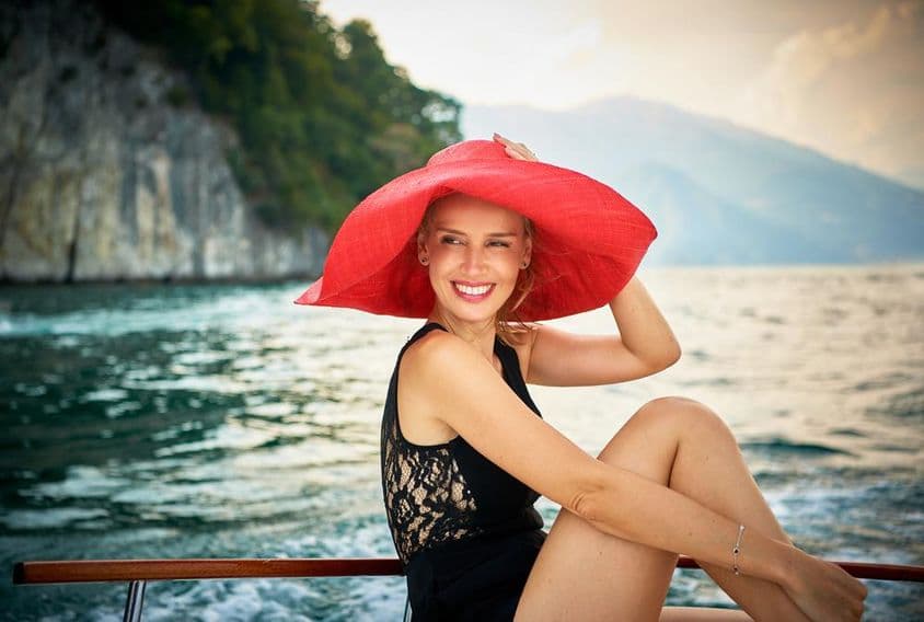 Modelo femenina fotografiada en un bote de motor de madera en el Lago Como, Italia.