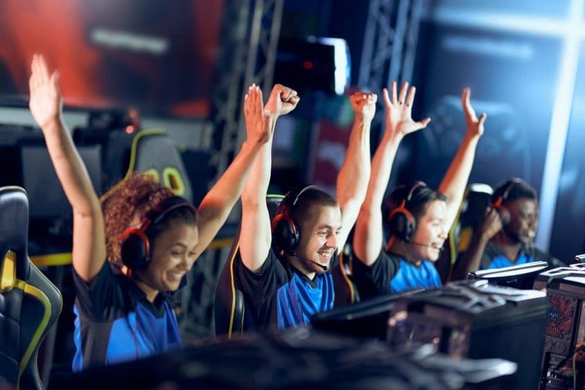 Un equipo jubiloso de gamers de ciberdeporte celebra su éxito durante una competición de esports.