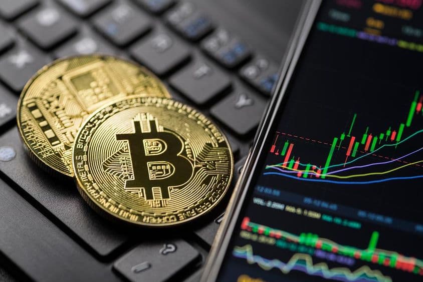Gráfico de comercio de criptomoneda de Bitcoin dorado en smartphone.