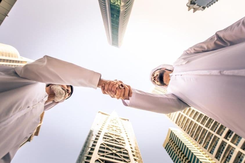 Empresarios reuniéndose al aire libre en Dubái, Emiratos Árabes Unidos.
