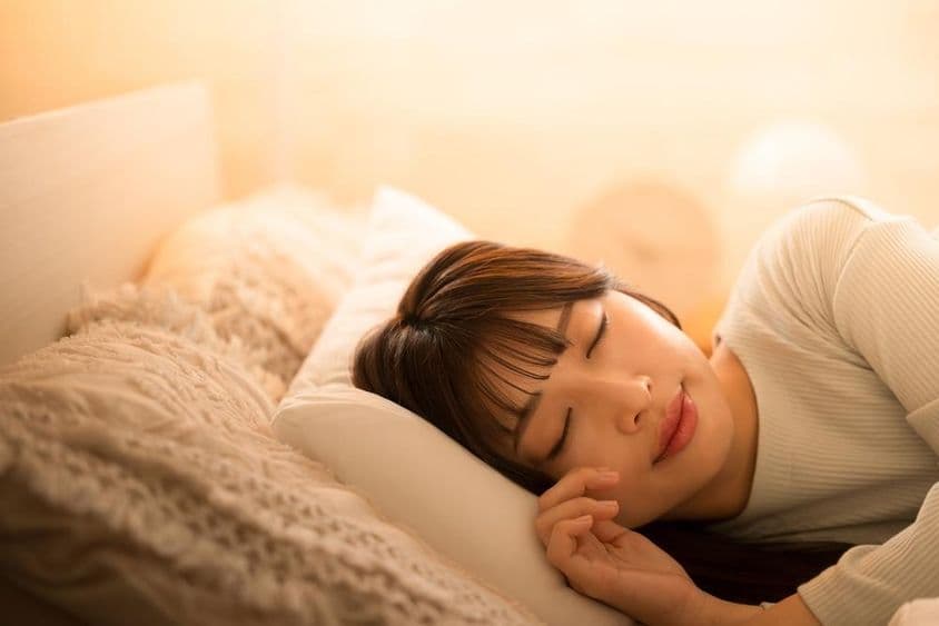 Una mujer durmiendo en la cama.