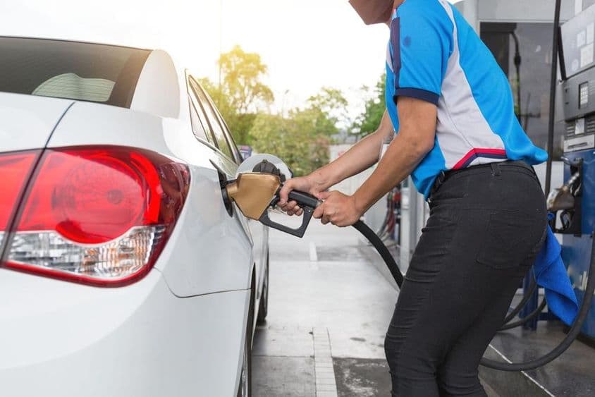 Persona repostando coche en una gasolinera de Dubái.