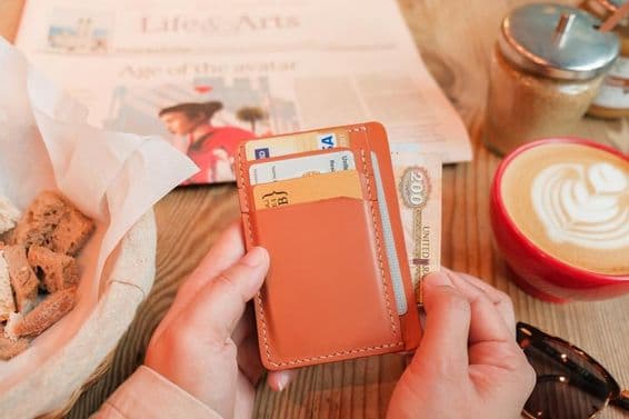 Tarjetero de cuero marrón con tarjetas de identificación, tarjetas bancarias y tarjetas de crédito.