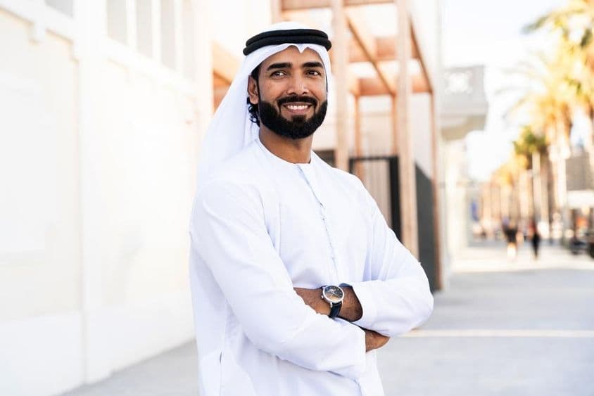 Hombre árabe tradicional vistiendo kandura emiratí al aire libre.