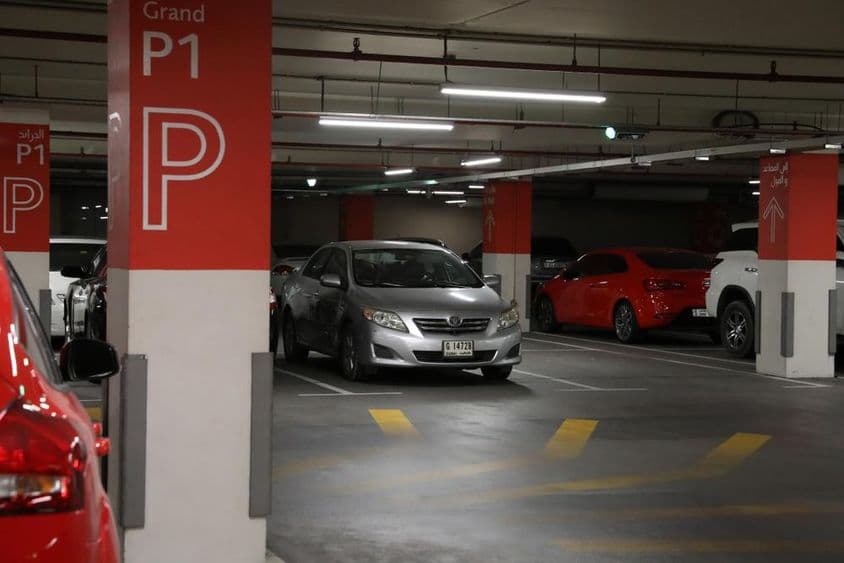 Garaje subterráneo moderno en Dubái con varios coches.