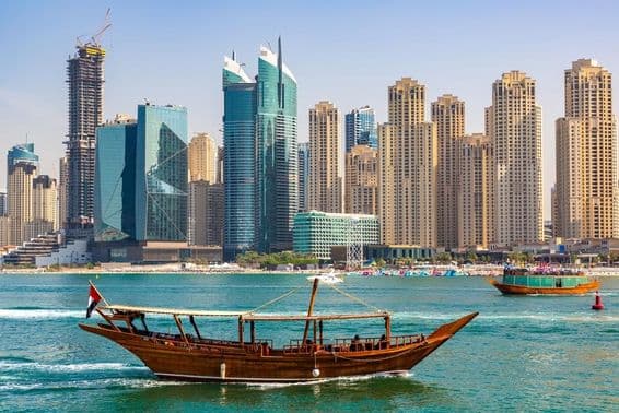 Antigua embarcación dhow de madera navegando en el Dubai Marina.