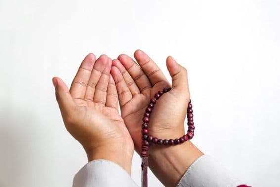 Musulmán rezando con cuentas de oración.