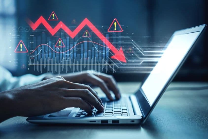 Gráfico de mercado, símbolos de alerta y tendencias de datos negativos.