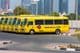 Línea de autobuses escolares amarillos de Dubai estacionados afuera.