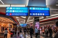 Pasajeros caminando hacia las puertas de salida en el Aeropuerto Internacional de Dubái
