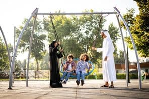 una familia jugando en el parque infantil en Dubái